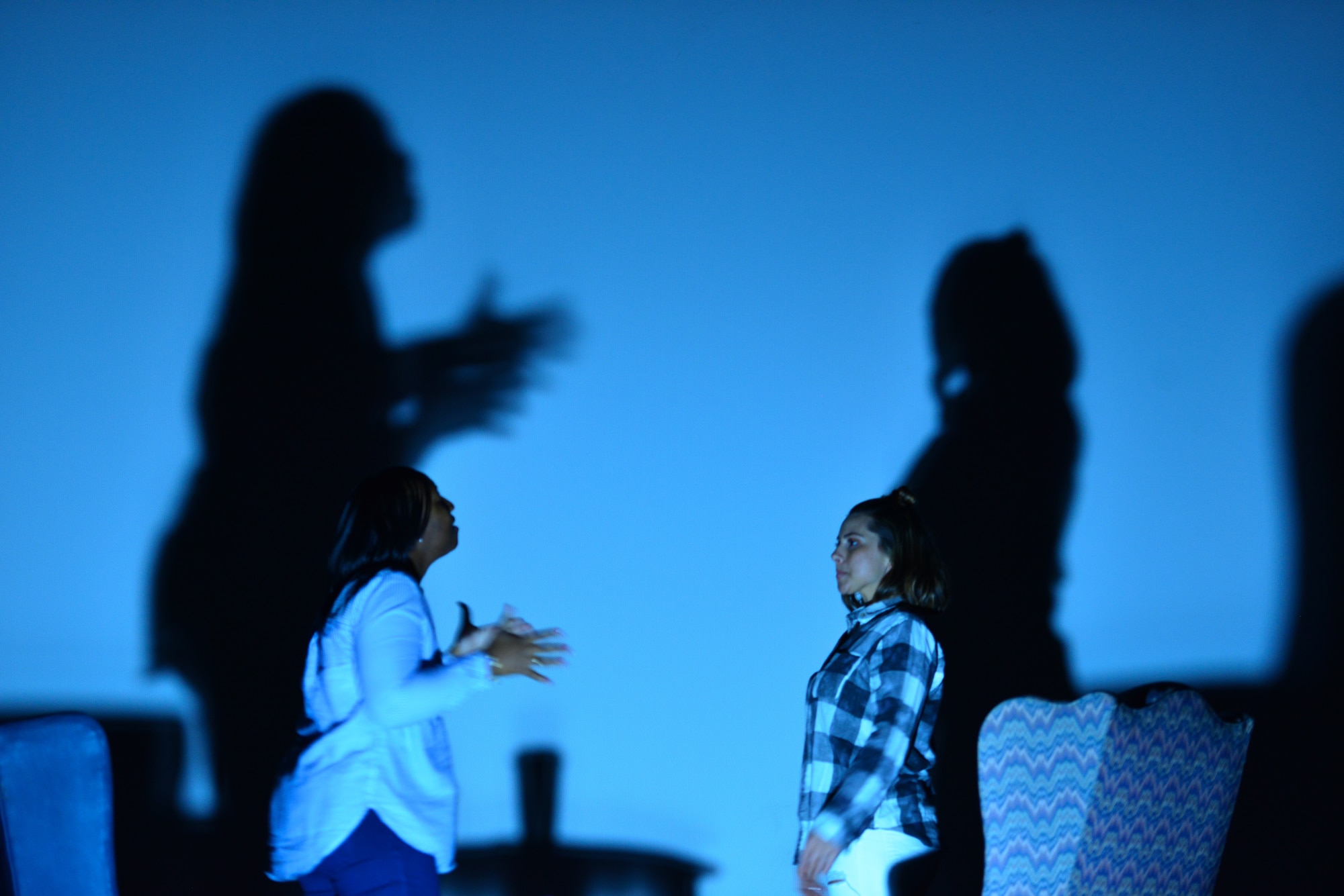 Master Sgt. Biagi Borrero, Air Combat Command occupational safety manager, portraying Airman First Class Houston [the victim], gives advice to Senior Airman Alyssa Beseman, 439th Supply Chain Operations Squadron, portraying Airman First Class Cox [the new Airman], during the Sexual Assault Theater Group performance of “Same Script, Different Cast” at Joint Base Langley-Eustis, Va., April 13, 2018. (U.S. Air Force photo by Senior Airman Ericha Guyote)