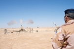 Iraqi soldier fires artillery.