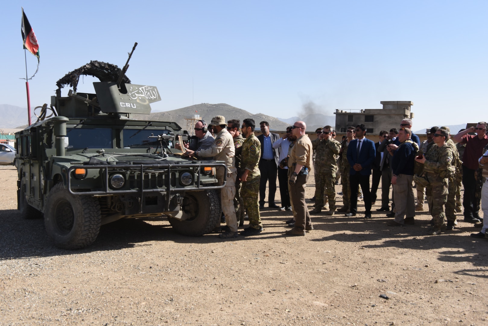NYPD Police Commissioner James O’Neil (center) fires an M249 Squad Automatic Weapon during his visit to the Crisis Response Unit (CRU) 222 in Kabul, Afghanistan, Apr. 11, 2018. Critical Response Unit (CRU) 222 is one of three National Mission Units that fall under the command and control of the General Command Police Special Unit. CRU 222 is the primary Afghan National Defense and Security Forces (ANDSF) capability for providing rapid response to high profile attacks within Kabul and the diplomatic community.