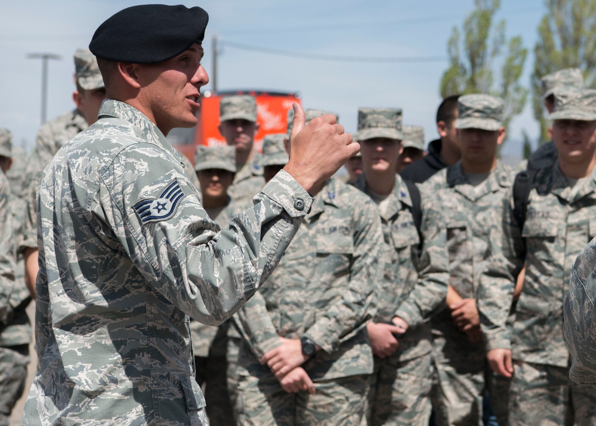 Staff Sgt. Tanner Theel, 377th Security Forces Squadron dog handler, talks to cadets before a military working dog demonstration during a visit to Kirtland Air Force Base, N.M April 11. More than 50 cadets visited several units as part of the base tour.