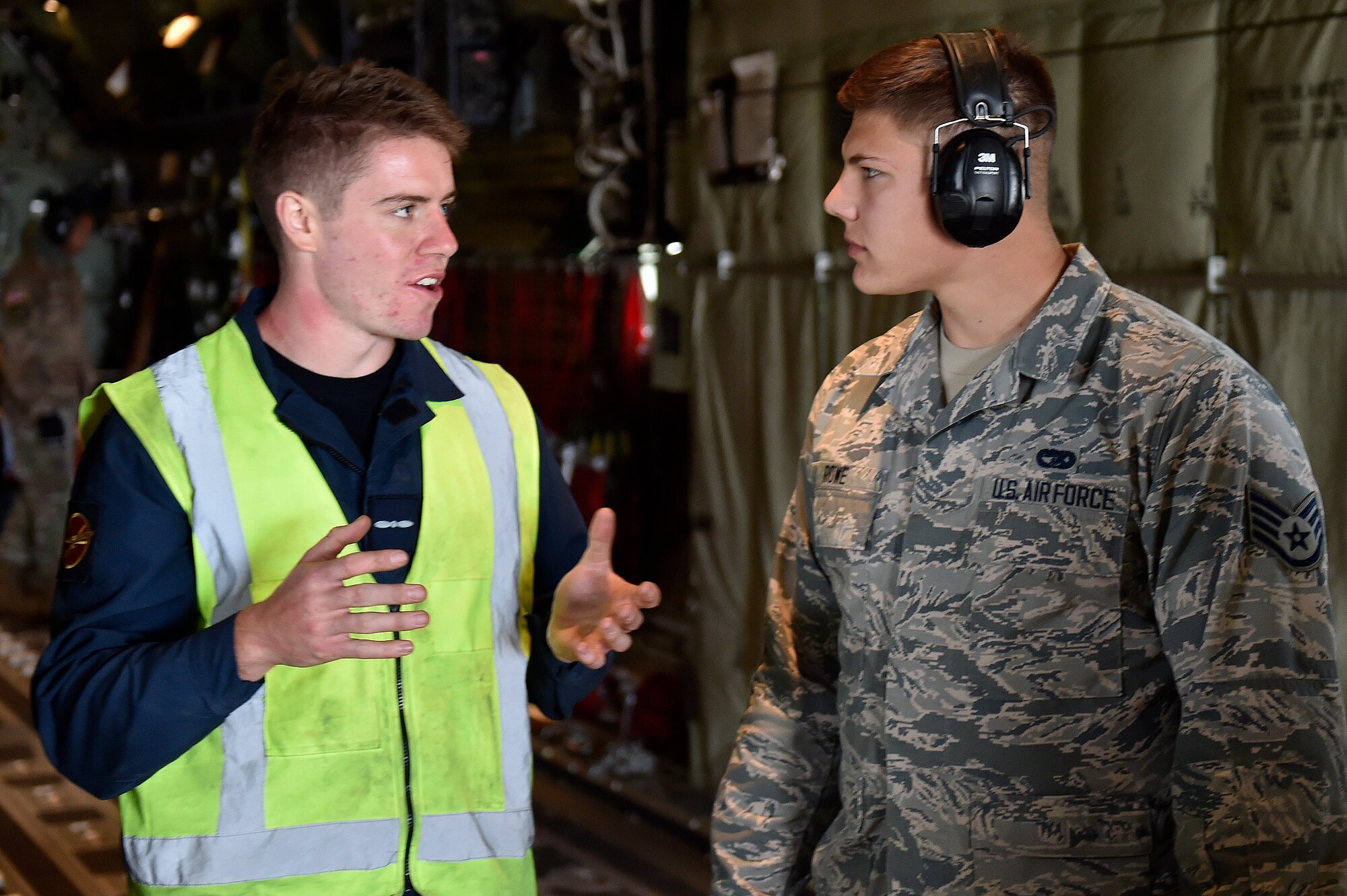 Royal New Zealand Air Force Leading Aircraftsman Thomas Larking and Staff Sgt. Jacob Rowe, 921st Contingency Response Squadron aerial porter, discuss load plans during the Joint Readiness Training Center exercise, April 8, 2018, at the Alexandria International Airport, La. The Airmen conducted joint training with Soldiers from the 2nd Brigade Combat Team, 82nd Airborne Division, providing direct air-land support for safe and efficient airfield operations. (U.S. Air Force photo by Tech. Sgt. Liliana Moreno/Released)