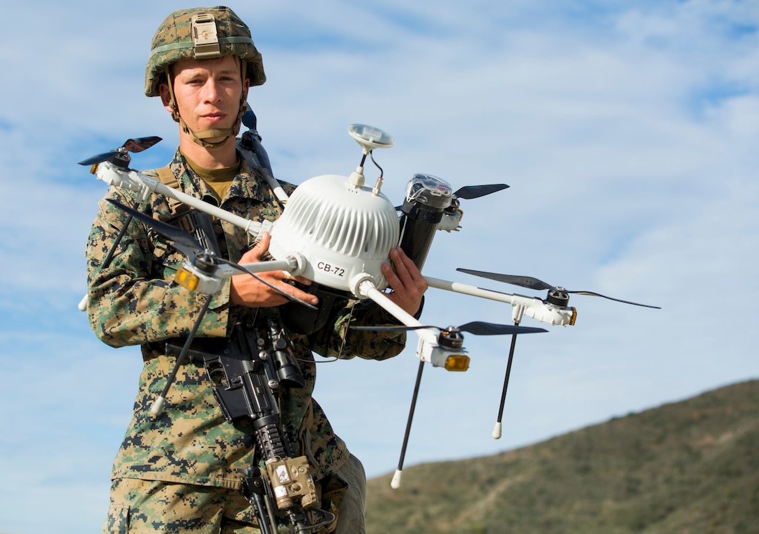 A U.S. Marine poses with a drone during Urban Advanced Naval Technology Exercise 2018 at Camp Pendleton, Calif.
