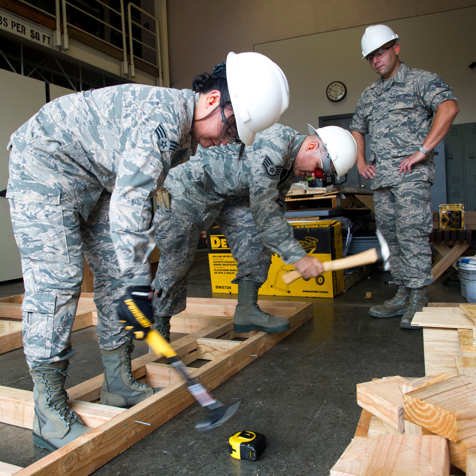 U.S. Air Force Airman Senior Airman Veleesa Conley, left, and Staff Sgt. Jeffrey Baez, structural engineers with the Air Force Reserve’s 624th Civil Engineer Squadron build a window frame, while Staff Sgt. Brandon Villanueva looks on during a unit training assembly April 8, 2018, at Joint Base Pearl Harbor-Hickam, Hawaii. The 624th CES is comprised of multiple Prime Base Engineer Emergency Force and Firefighting teams ready to support worldwide deployments to construct and maintain airfield and facilities, provide firefighting support, and coordinate planning for any real world disasters. (U.S. Air Force photo by Master Sgt. Theanne Herrmann)