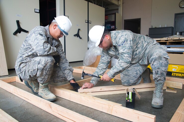U.S. Air Force Airman 1st Class John-David Iaea ,left, and Airman Nicholas Montijo, structural engineers with the Air Force Reserve’s 624th Civil Engineer Squadron build a window frame during a unit training assembly April 8, 2018, at Joint Base Pearl Harbor-Hickam, Hawaii. The 624th CES is comprised of multiple Prime Base Engineer Emergency Force and Firefighting teams ready to support worldwide deployments to construct and maintain airfield and facilities, provide firefighting support, and coordinate planning for any real world disasters. (U.S. Air Force photo by Master Sgt. Theanne Herrmann)