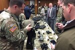 A soldier from Program Executive Office Soldier shows off the new enhanced binocular night-vision goggles helmet during a demonstration at Fort Belvoir, Va.