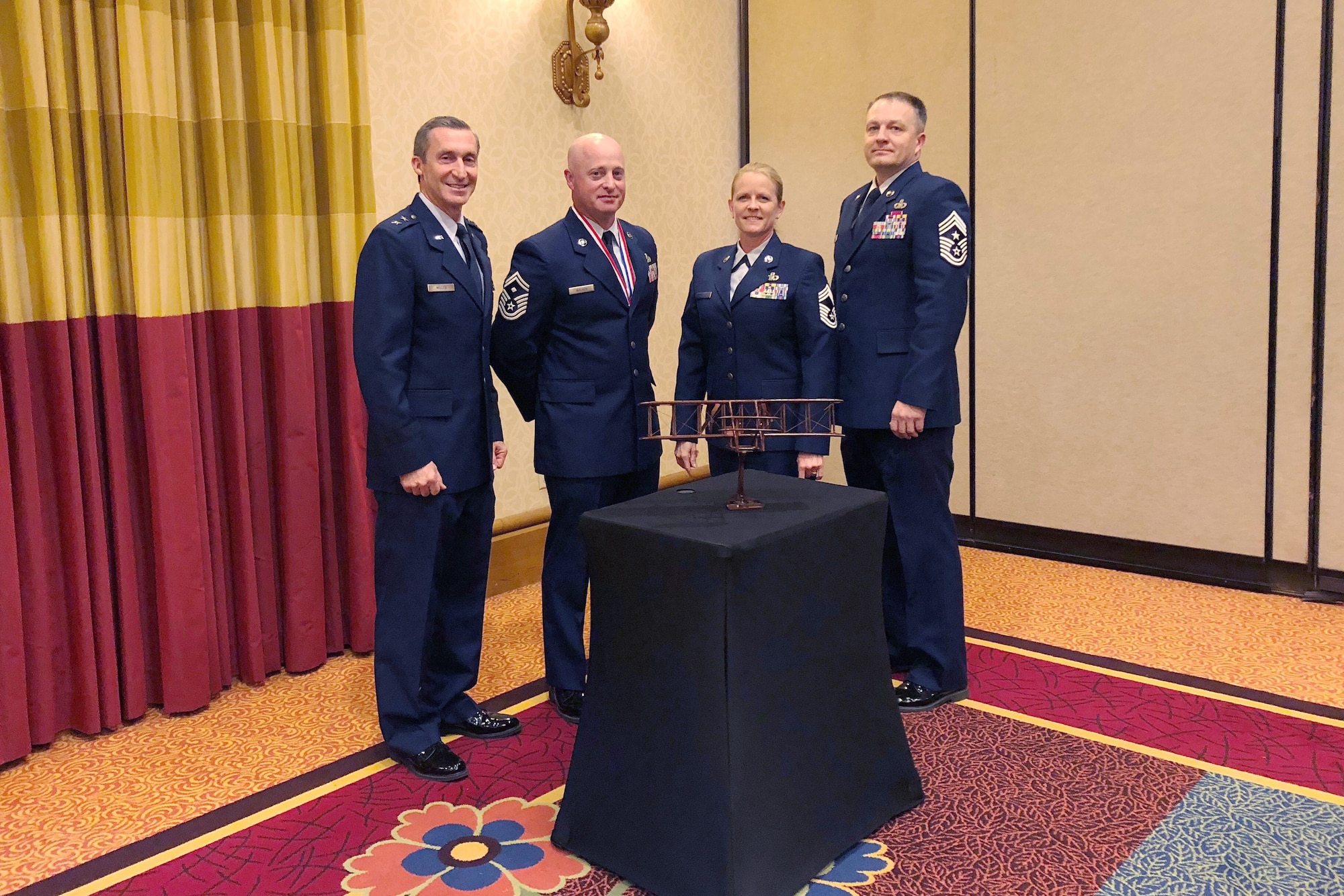 Maj. Gen. Ronald Miller, 10th Air Force commander, Senior Master Sgt. Richard Walker, 924th Maintenance Squadron first sergeant, Chief Master Sgt. Catherine Buchanan, 924 Fighter Group superintendent, Chief Master Sgt. James Loper, 10th Air Force command chief pose together at the Enlisted Symposium Air Force Reserve Outstanding Airmen on the Year banquet 28 March.