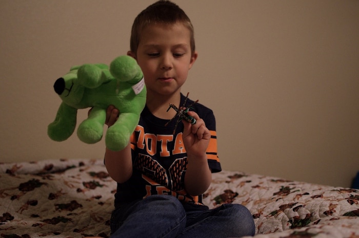 Tristan Kulikowski, Kambri’s older brother, plays in his room with his toy helicopter and a stuffed animal dog that has a gastrostomy tube like his sister, April 12, 2018. Kortni and her husband, Capt. Jeremy Kulikowski, Air Force Life Cycle Management Center cyber mobile command and control systems officer, said Tristan was given this stuffed animal dog when Kambri was getting a G-tube surgically inserted at Memorial Hospital in Colorado Springs when she was 3 weeks old in 2017. (U.S. Air Force photo by Audrey Jensen)