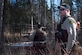 Mark Sledge, 673d Civil Engineering Squadron senior conservation law enforcement officer, and James Wendland, 673 CES chief conservation law enforcement officer, approach a black bear den at Joint Base Elmendorf-Richardson, Alaska, April 16, 2018. Making loud noises while walking the trails will alert the wildlife of your presence and reduce a surprise encounter.
