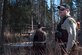 Mark Sledge, 673d Civil Engineering Squadron senior conservation law enforcement officer, and James Wendland, 673 CES chief conservation law enforcement officer, approach a black bear den at Joint Base Elmendorf-Richardson, Alaska, April 16, 2018. Making loud noises while walking the trails will alert the wildlife of your presence and reduce a surprise encounter.