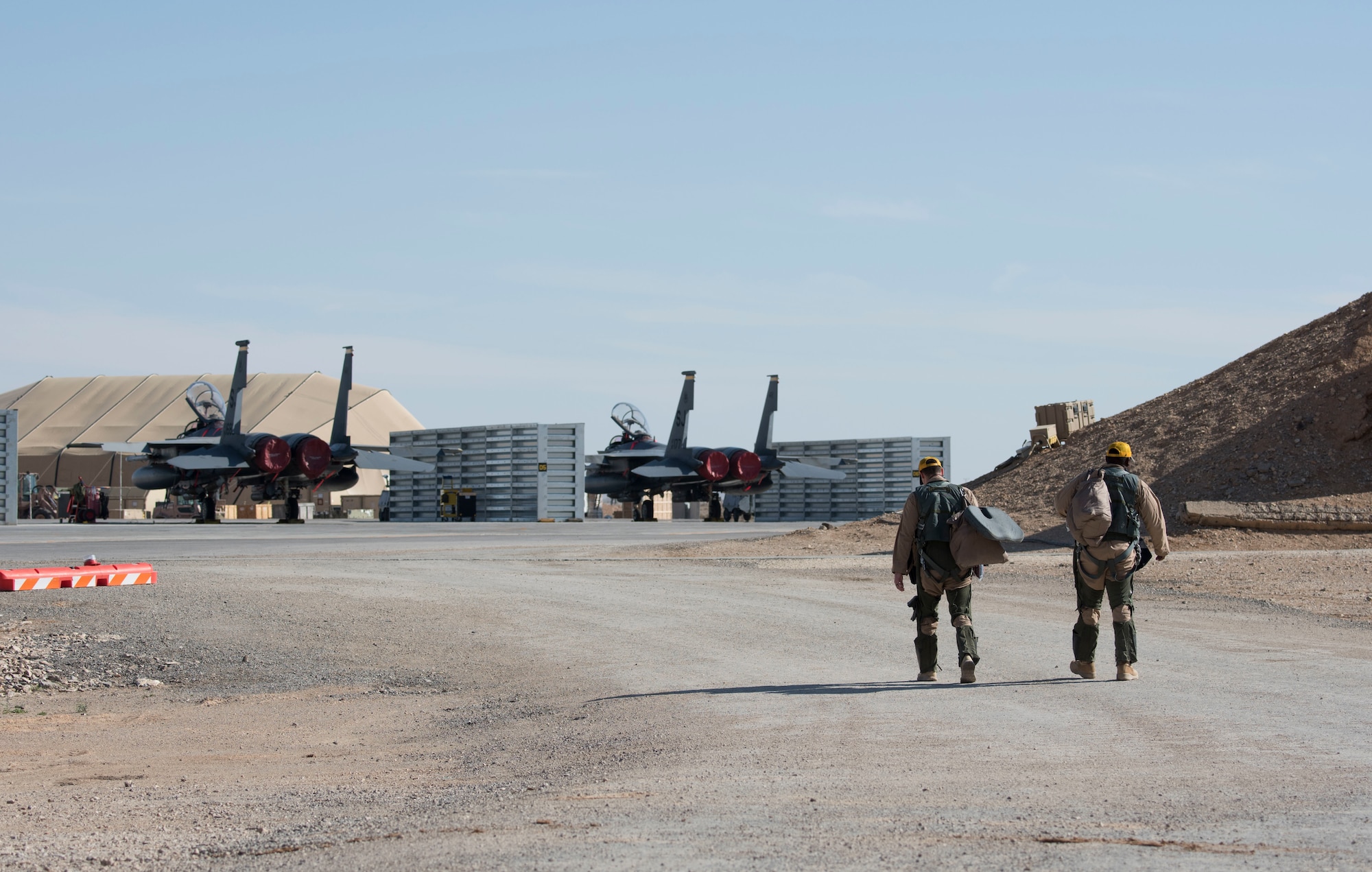 A 332nd Air Expeditionary Fighter Squadron pilot and weapon system officer walk to their aircraft, an F-15E Strike Eagle, in preparation for launch March 7, 2018, at an undisclosed location in Southeast Asia.