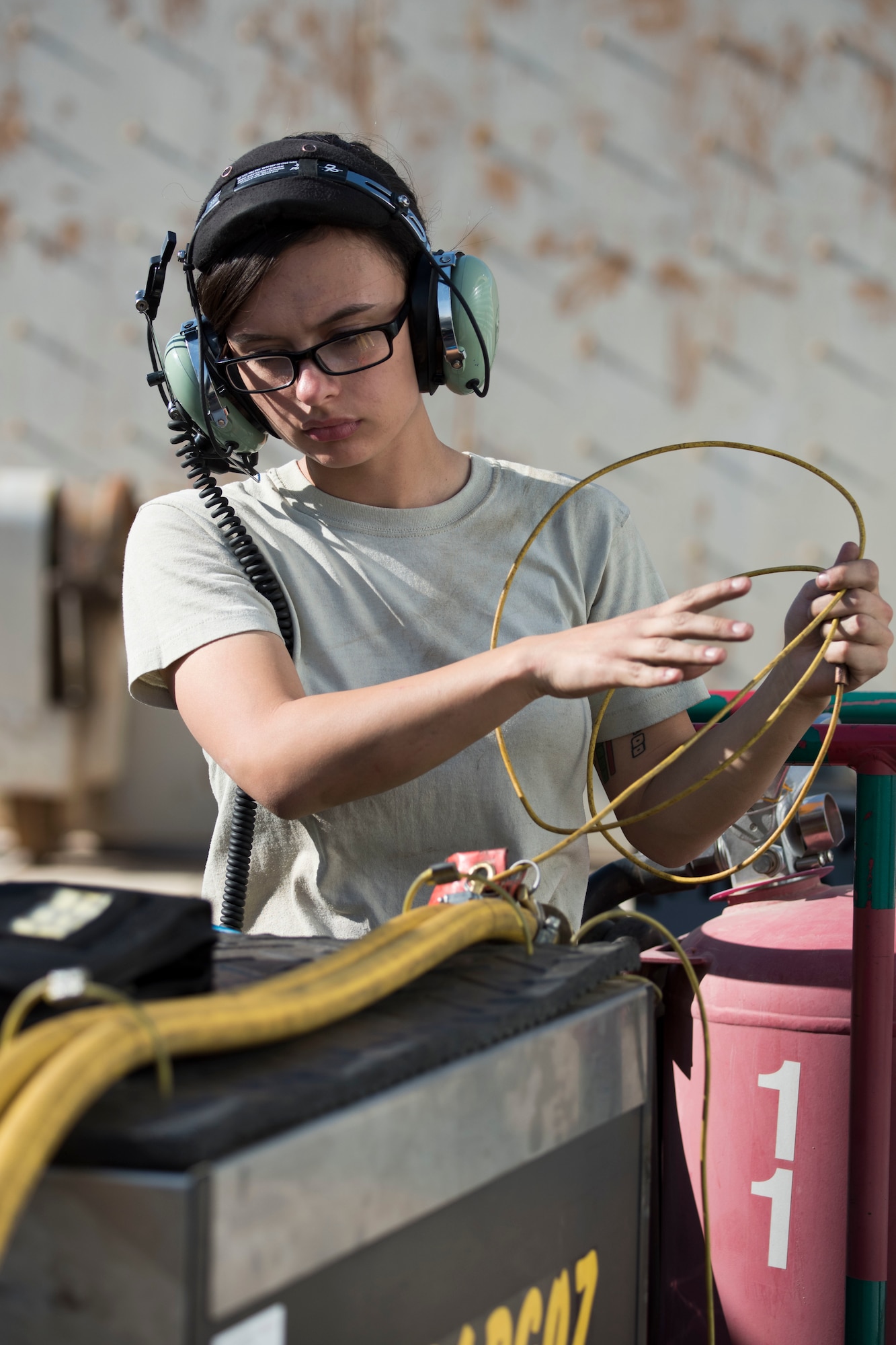 A 332nd Expeditionary Maintenance Squadron crew chief gathers equipment to assist with completing pre-checks of an F-15E Strike Eagle prior to launch March 7, 2018, at an undisclosed location in Southeast Asia.