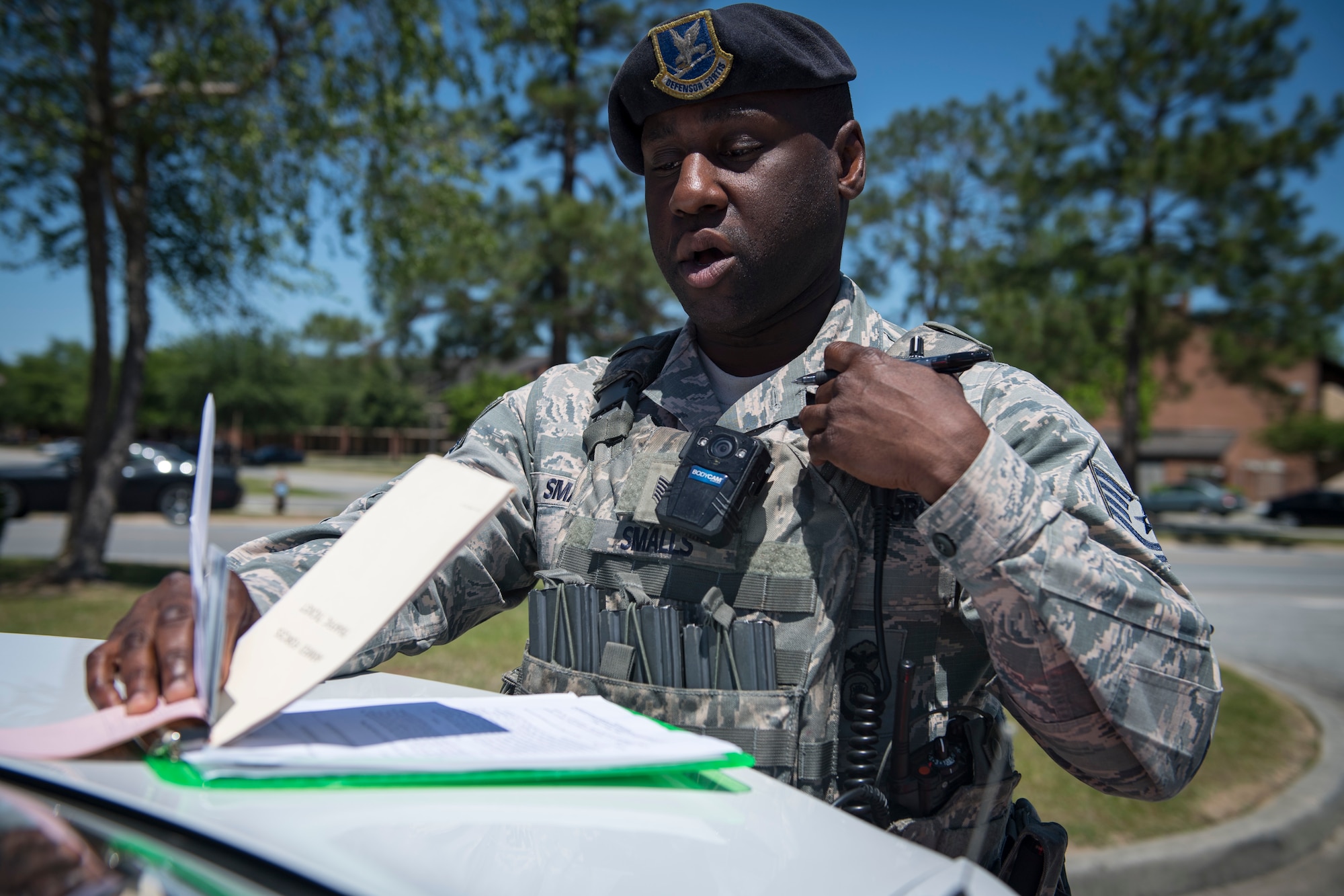 Tech. Sgt. Jamaal Smalls, 23d Security Forces Squadron (SFS) flight chief, relays information from a simulated distracted driving traffic stop to an operations center, April 17, 2018, at Moody Air Force Base, Ga. Since January 2018 there have been 13 distracted driving incidents at Moody, which has prompted the SFS patrolmen to heavily enforce distracted driver consequences for motorists on the installation. (U.S. Air Force photo by Senior Airman Janiqua P. Robinson)