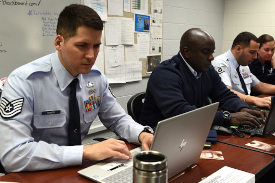 Airmen work on their computers.