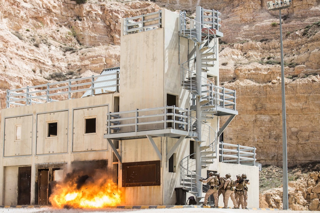 U.S. Marines assigned to the Maritime Raid Force, 26th Marine Expeditionary Unit, brace while an entrance is breached during Eager Lion at the King Abdullah II Special Operations Training Center, Jordan, April 18, 2018. As part of Eager Lion, U.S. Navy and Marine Corps assets practice and rehearse a range of critical capabilities available to U.S. Central Command both afloat and ashore to promote stability in the region.