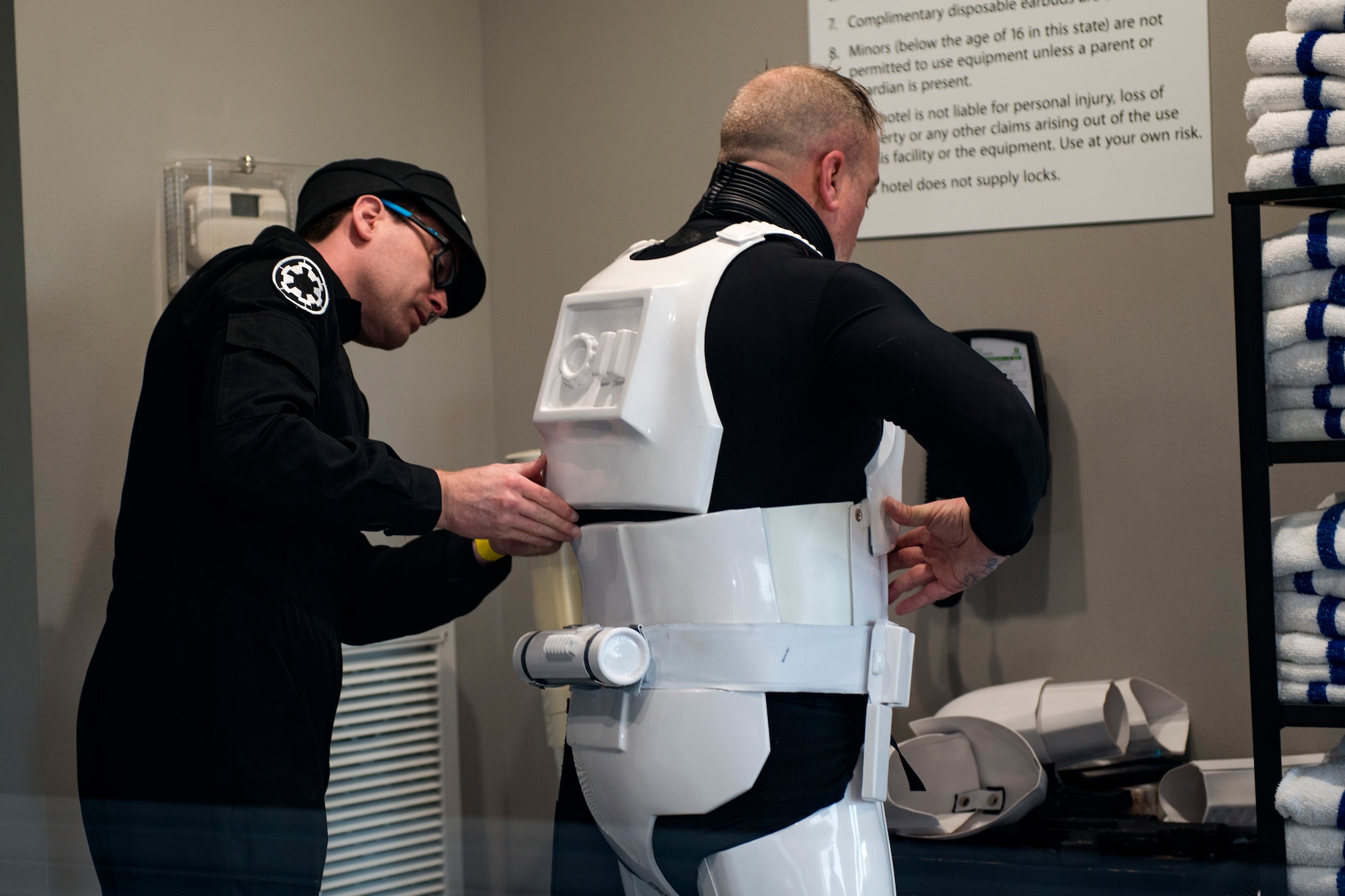 Shane Massey, left, cosplayer, helps adjust the costume of Greg Ferrell, cosplayer, while at Tiger Con, April 14, 2018, in Valdosta, Ga. Tiger Con was a convention, open to Moody residents and the local community, geared toward giving pop culture enthusiasts a chance to dress and role play as their favorite movie, TV show or comic characters. The event included a costume contest, an anime themed café, pop-culture artist panels along with shopping vendors and a guest appearance of veteran voice actor Richard Epcar, who’s known for portraying Raiden in the video series Mortal Kombat. (U.S. Air Force photo by Airman 1st Class Erick Requadt)