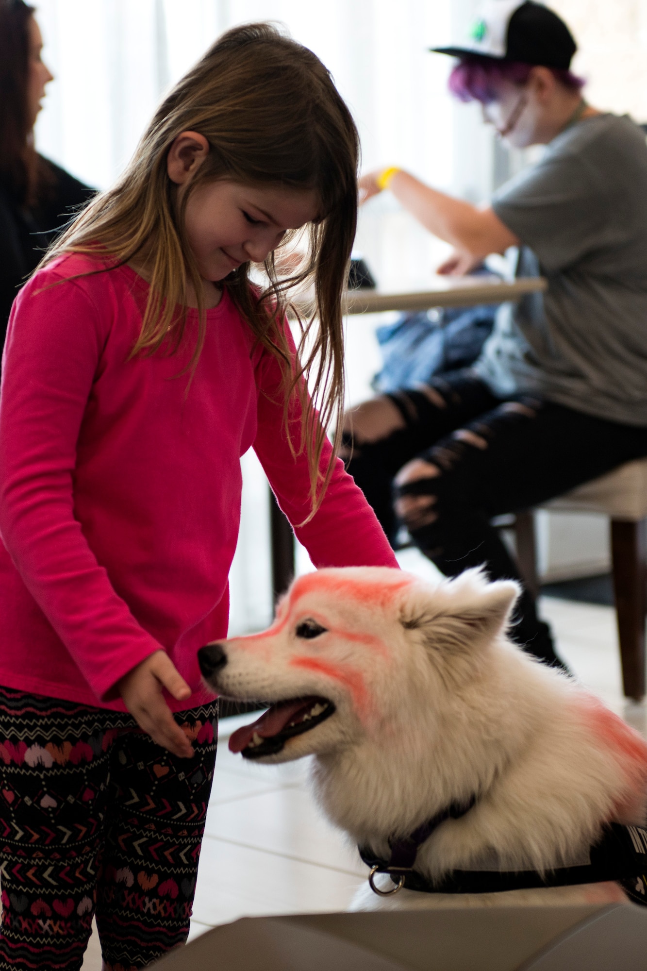 Kate pets a dog cosplayer while at Tiger Con, April 14, 2018, in Valdosta, Ga. Tiger Con was a convention, open to Moody residents and the local community, geared toward giving pop culture enthusiasts a chance to dress and role play as their favorite movie, TV show or comic characters. The event included a costume contest, an anime themed café, pop-culture artist panels along with shopping vendors and a guest appearance of veteran voice actor Richard Epcar, who’s known for portraying Raiden in the video series Mortal Kombat. (U.S. Air Force photo by Airman 1st Class Erick Requadt)
