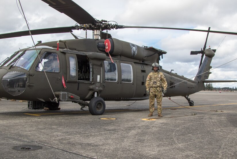 Soldier works on helicopter.