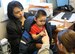 Major Sue Diaz, 110th Medical Group, Michigan Air National Guard connects with a young patient at the Kivalina Clinic, Kivalina, Alaska, April 18, 2018, while deployed in support of Arctic Care 2018. Sponsored by the Office of the Secretary of Defense Reserve Affairs, Innovative Readiness Training exercises such as Arctic Care demonstrate the clinical and logistical ability of the United States military while providing medical care to underserved regions of the U.S. (U.S. Air Force photo by Maj. Joseph Simms)