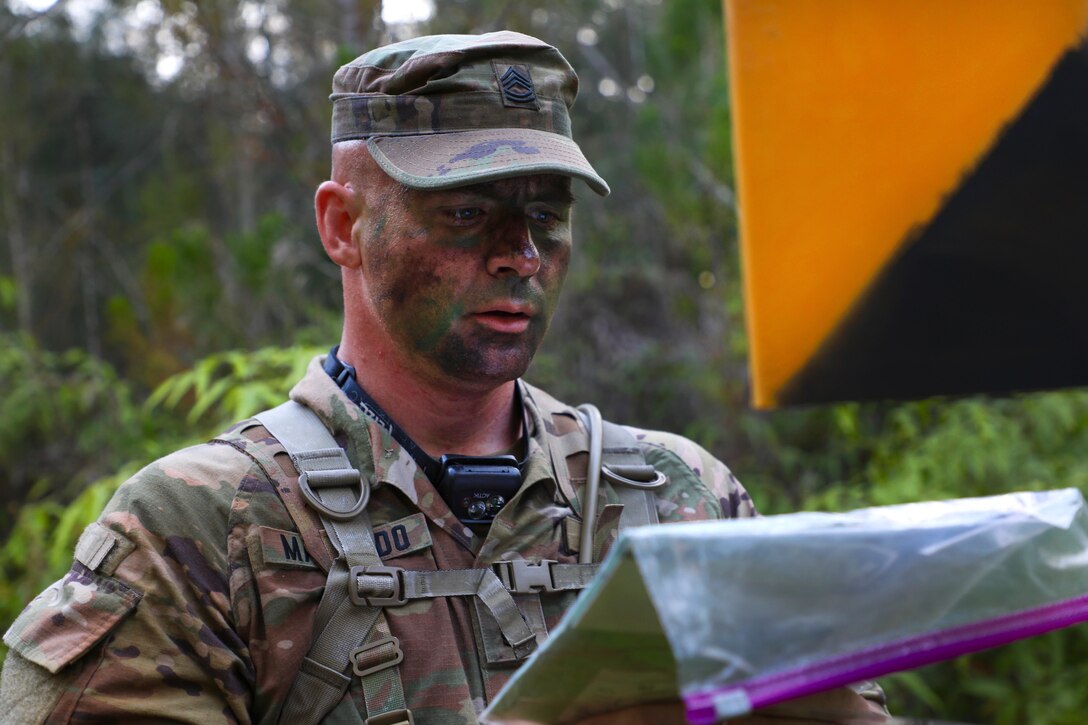 A soldier reads instructions during land navigation qualification.