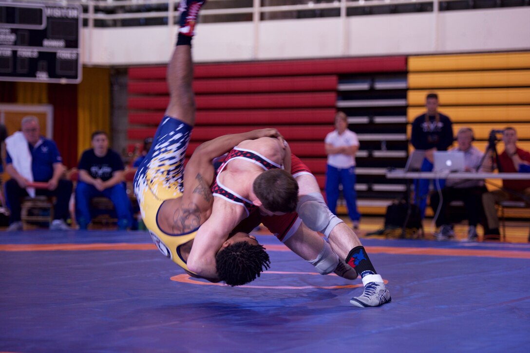 Capt. Brandon Mueller, in blue, takes down Army's Austin Craig at the 2018 Armed Forces Championships.  Mueller, Air Force Research Laboratory’s Space Vehicles Directorate, will compete in Las Vegas in April