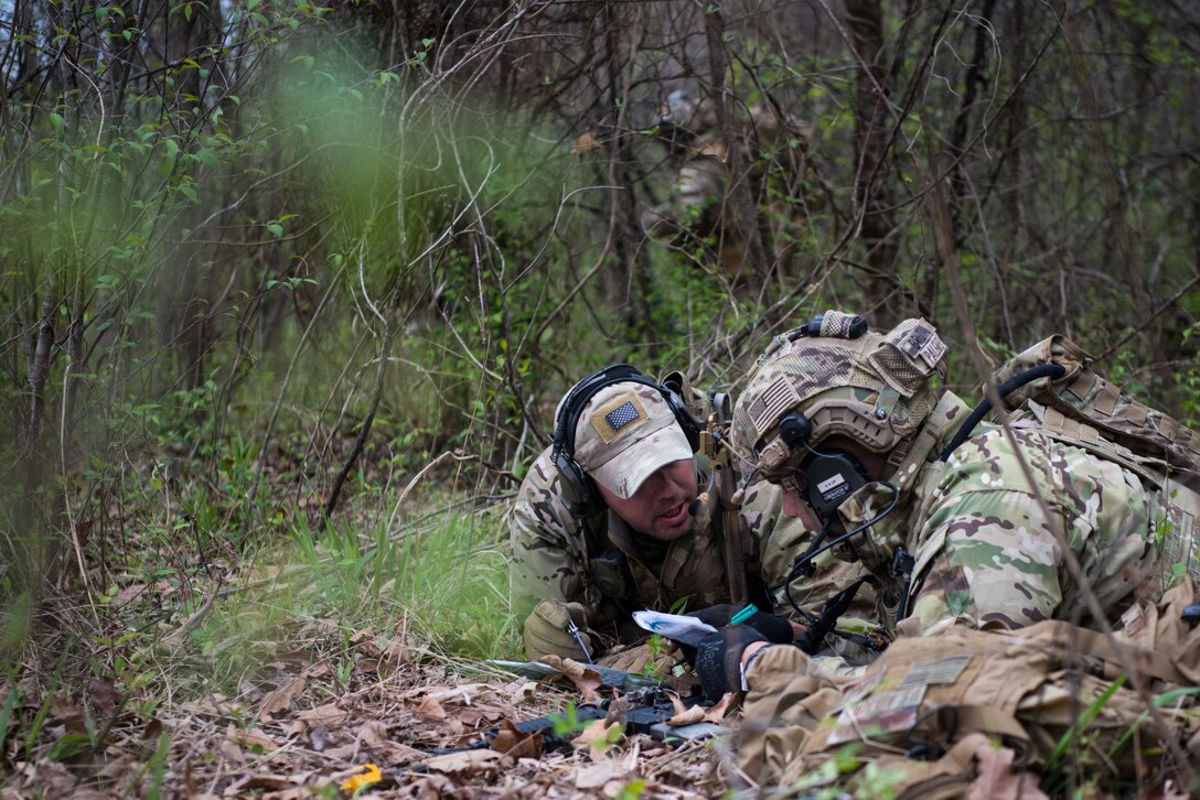 A Tactical Air Control Party specialist talks with an instuctor while participating in a field training exercise, or FTX, at Fort Chaffee Maneuver Training Center in Arkansas, April 14, 2018. The FTX, April 13-17, 2018, took place at the end of a two-month Initial Combat Skills Training Course, which is hosted by the 138th Combat Training Flight at Will Rogers Air National Guard Base in Oklahoma City, and is the only one of its kind in the U.S. Air Force. (U.S. Air National Guard Photo by Staff Sgt. Kasey M. Phipps)
