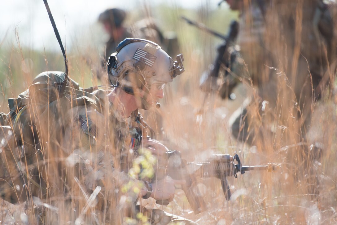 A Tactical Air Control Party specialist listens to his team on his radio while participating in a field training exercise, or FTX, at Fort Chaffee Maneuver Training Center in Arkansas, April 14, 2018. The FTX, April 13-17, 2018, took place at the end of a two-month Initial Combat Skills Training Course, which is hosted by the 138th Combat Training Flight at Will Rogers Air National Guard Base in Oklahoma City, and is the only one of its kind in the U.S. Air Force. (U.S. Air National Guard Photo by Staff Sgt. Tyler K. Woodward)