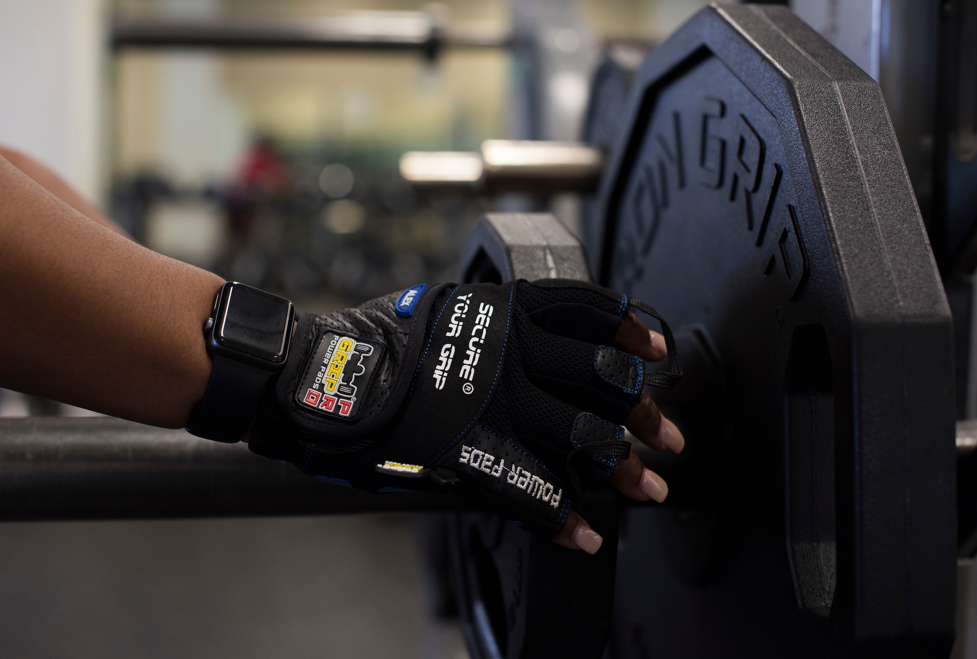 U.S. Air Force Staff Sgt. Ashley Bethel, 33rd Maintenance Squadron Command Support Staff noncomissioned officer in charge, loads a barbell with weights March 29, 2018, at Eglin Air Force Base, Fla. Bethel strength trains on a daily basis to stay physically and mentally fit. (U.S. Air Force photo by Airman 1st Class Daniella Peña-Pavao)