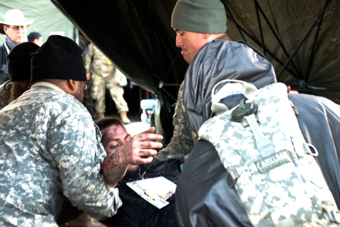Soldiers process simulated casualties during a training exercise.