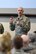 U.S. Air Force Chief Master Sgt. Ronald C. Anderson, command chief master sgt. for the Air National Guard, shows his coin and explains its significance to the Airmen of the 180th Fighter Wing, Ohio Air National Guard, during his visit April 11, 2018. Air Force leaders award speciially designed coins to Airmen who've achieved great accomplishments during their time in service. (U.S. Air National Guard photo by Staff Sgt. Shane Hughes)