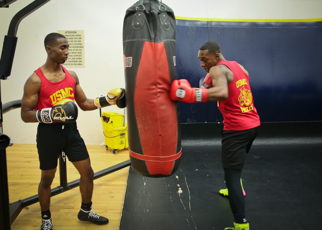 Cpl. Oubigee Jones assists Lance Cpl. Keandre Blackshire practice striking techniques aboard Marine Corps Air Station Beaufort April 17. The Marines fought in the Marine Corps and Chevrolet Freedom Fight exhibition aboard Marine Corps Base Camp Lejeune April 14. Jones and Blackshire are Administrative Specialists with the Installation Personnel Administrative Center.