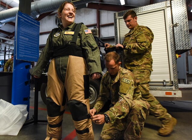 Jessica Rye, left, 17-year-old cancer survivor, tries on an Explosive Ordnance Disposal bomb suit April 12, 2018, at Joint Base Charleston, S.C.