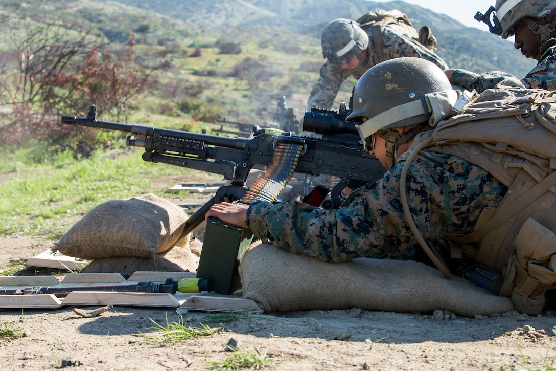 Marines fire an M240B machine gun.