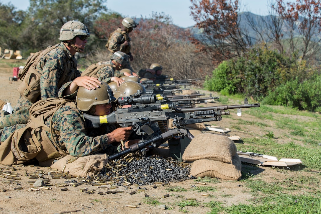 Marines shoot a machine gun as part of the final exercise.