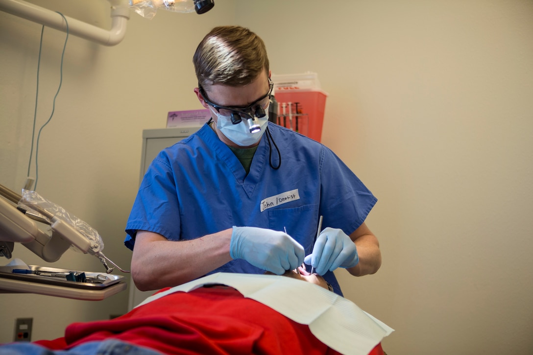 U.S. Navy Lt Commander John Morris, a dental officer with 4th Dental Battalion, 4th Marine Logistics Group, provides dental service to locals as part of Innovative Readiness Training Arctic Care 2018, Buckland, Alaska, April 18, 2018.