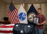 U.S. Army Spc. Zachary Boney poses next to the remains of his deceased great grandfather, U.S. Army Master Sgt. Finley Davis during a tour of the Defense POW/MIA Accounting Agency (DPAA) on Joint Base Pearl Harbor - Hickam, Hawaii, April 16, 2018. Master Sgt. Finley served in Delta comany, 2nd engineer battalion, 2nd Infantry Division when he was captured as a prisoner of war in Kunu-ri, camp 5, North Korea. (U.S. Army Photo by Staff Sgt. Jamarius Fortson)