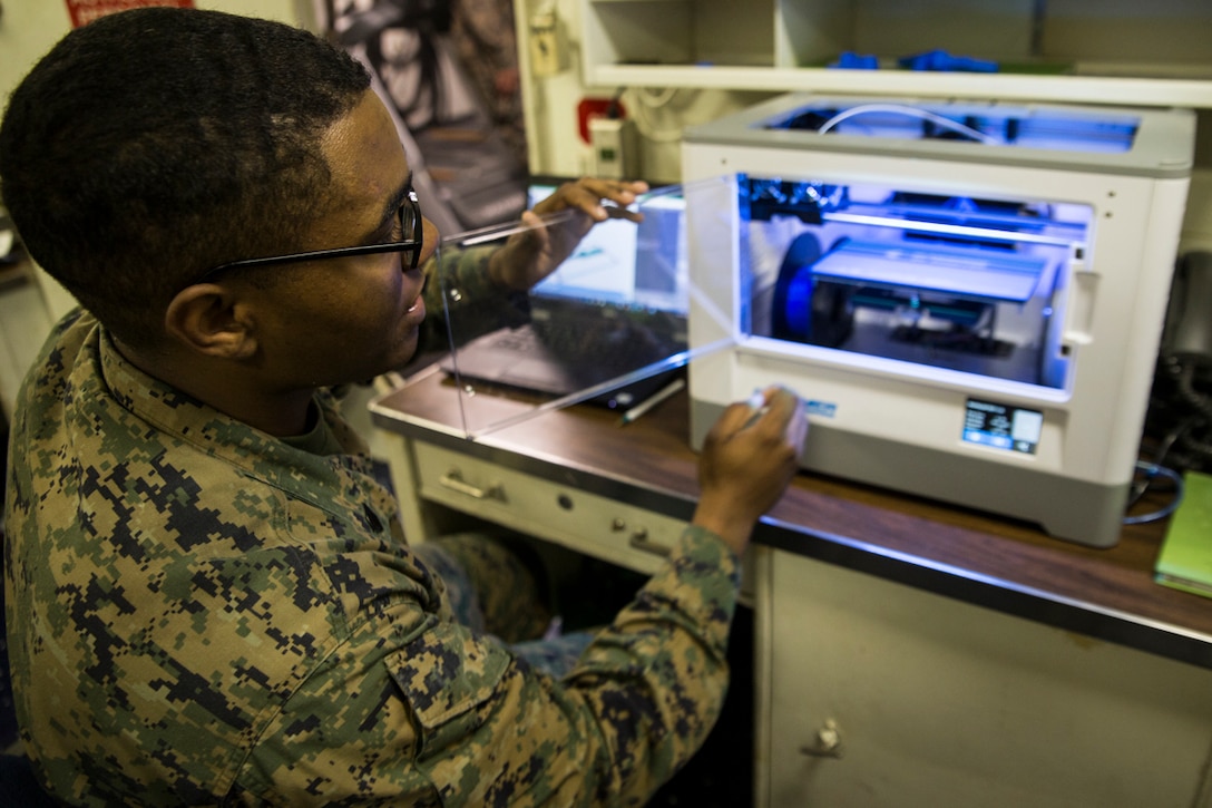 Sgt. Adrian Willis, a computer and telephone technician with Combat Logistic Battalion 31, 31st Marine Expeditionary Unit, explains the functions of a 3-D printer aboard the USS Wasp (LHD-1) while underway in the Pacific Ocean, March 22, 2018. Marines with CLB-31 are now capable of ‘additive manufacturing,’ also known as 3-D printing, which is the technique of replicating digital 3-D models as tangible objects. The 31st Marine Expeditionary Unit partners with the Navy’s Amphibious Squadron 11 to form the Wasp Amphibious Ready Group, a cohesive blue-green team capable of accomplishing a variety of missions across the Indo-Pacific. (U.S. Marine Corps photo by Cpl. Stormy Mendez/Released)
