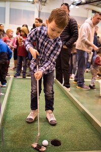 Michael, 5, son of Marty Martinez, swings a putter in a golf game during the Month of the Military Child Carnival at Joint Base Elmendorf-Richardson’s 2Rivers Youth Center, April 13, 2018. The event consisted of games, cotton candy, popcorn, face painting and more. April is the Month of the Military Child, highlighting the significant role military children play in the armed forces community.