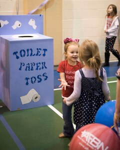 Sophia, 4, daughter of Spc. Kevin O’Brien, celebrates with a friend during a toilet paper toss game during the Month of the Military Child Carnival at Joint Base Elmendorf-Richardson’s 2 Rivers Youth Center, April 13, 2018. The event consisted of games, cotton candy, popcorn, face painting and more. April is the Month of the Military Child, highlighting the significant role military children play in the armed forces community.