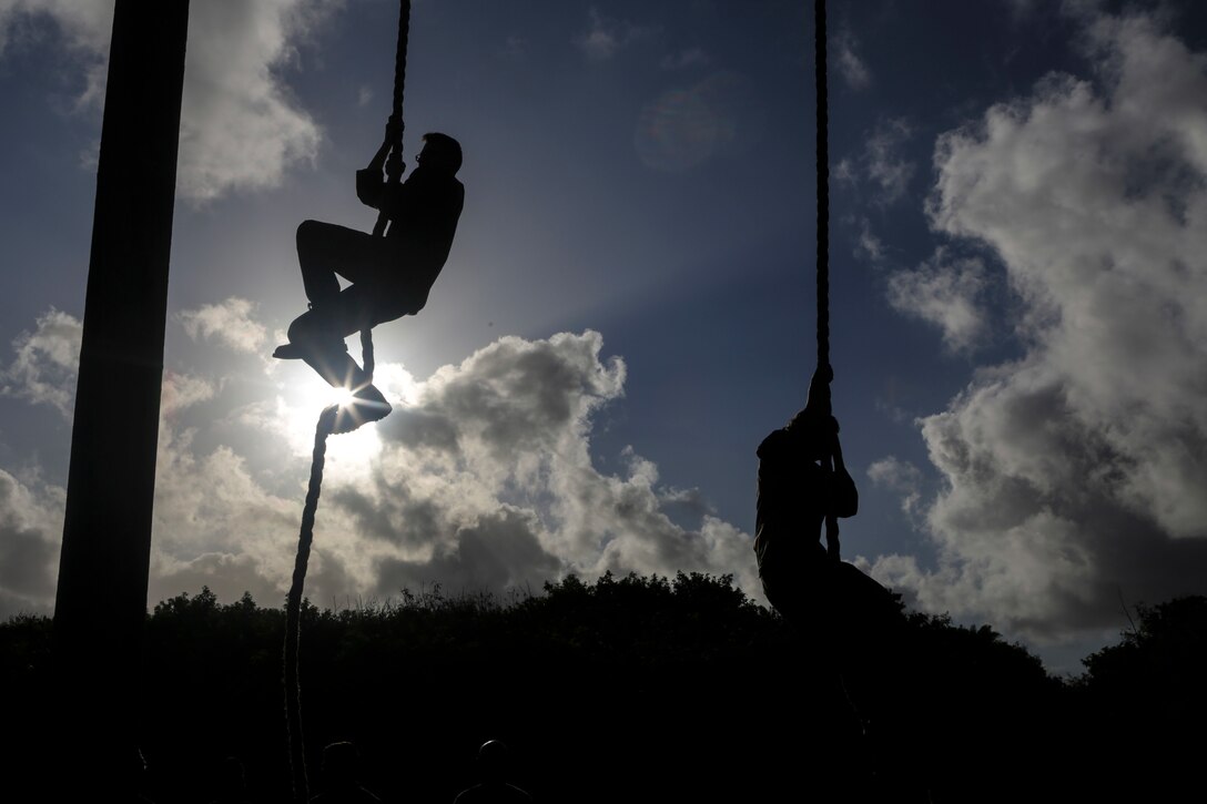 U.S. Marines with U.S. Marine Corps Forces, Pacific climb the rope portion of an obstacle course at Landing Zone Boondocker on Marine Corps Base Hawaii April 13, 2018. The Marines completed the obstacle course and leader’s reaction course to improve combat conditioning and enhance small unit leadership skills. (U.S. Marine Corps photo by Lance Cpl. Adam Montera)