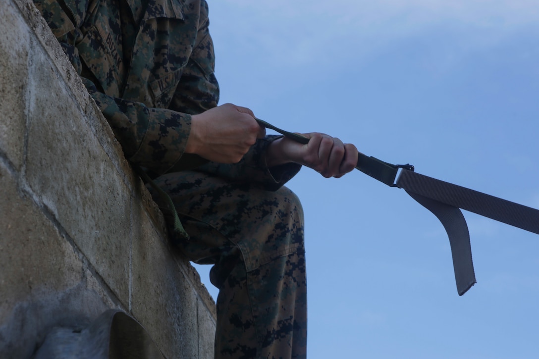 A U.S. Marine with U.S. Marine Corps Forces, Pacific holds an improvised rope made out of belts at a leader’s reaction course station at Landing Zone Boondocker on Marine Corps Base Hawaii April 13, 2018. The Marines completed the obstacle course and leader’s reaction course to improve combat conditioning and enhance small unit leadership skills. (U.S. Marine Corps photo by Lance Cpl. Adam Montera)
