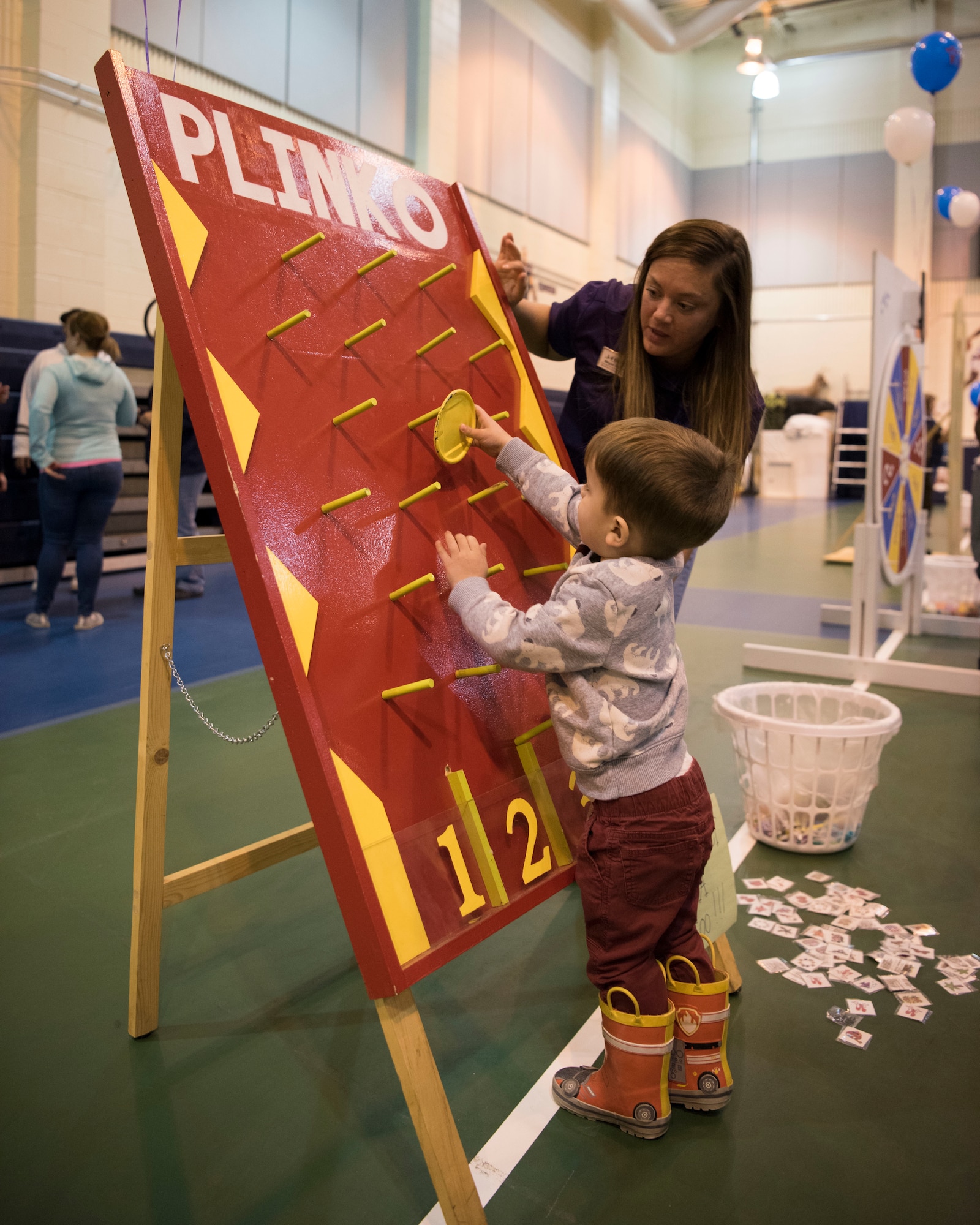 Noah, 3, son of Air Force Staff Sgt. Michael Coghill, drops a token down a plinko game during the Month of the Military Child Carnival at Joint Base Elmendorf-Richardson’s 2Rivers Youth Center, April 13, 2018. The event consisted of games, cotton candy, popcorn, face painting and more. April is the Month of the Military Child, highlighting the significant role military children play in the armed forces community.