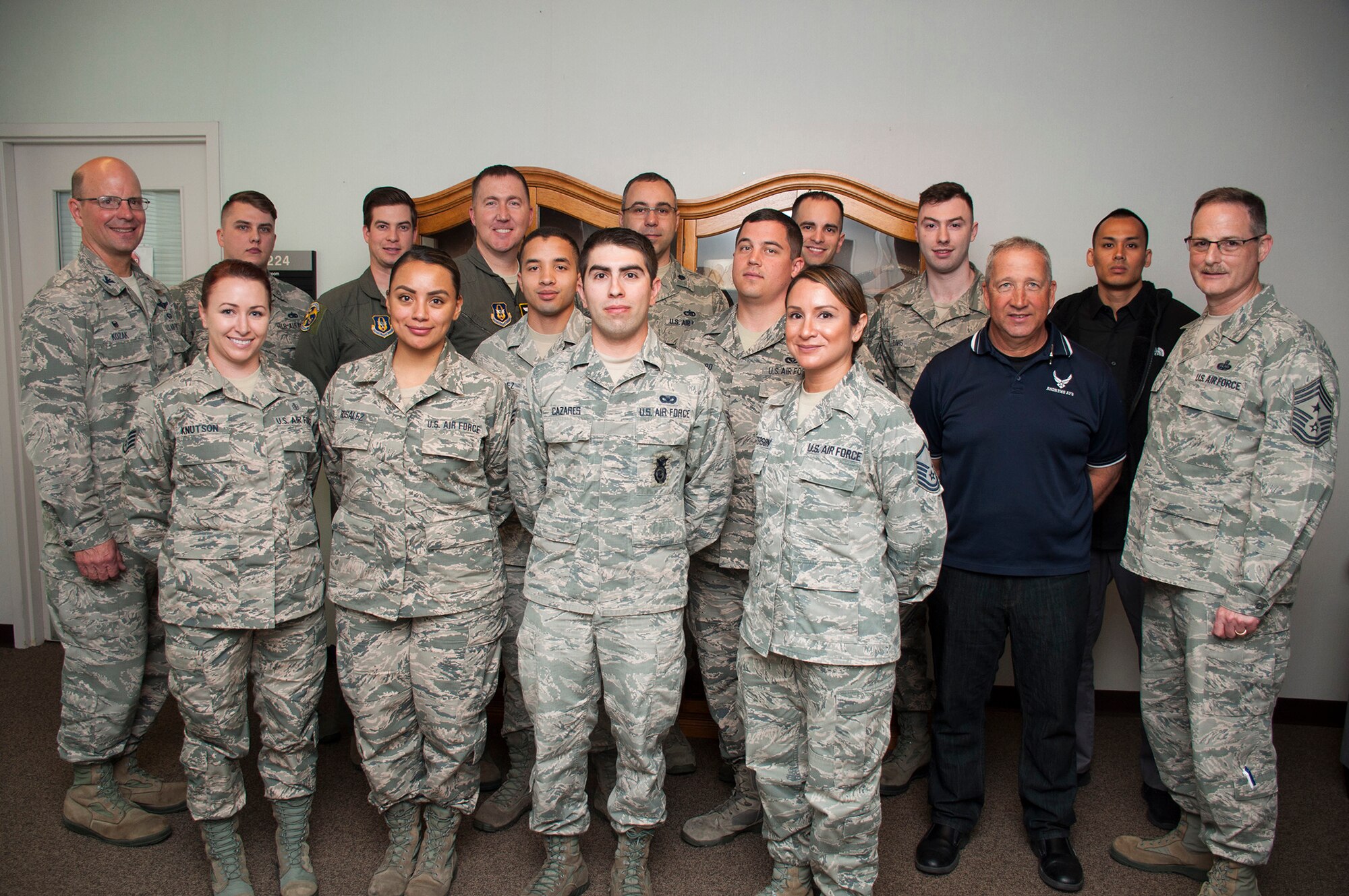 Col. Raymond Kozak, 349th Air Mobility Wing commander, and Chief Master Sgt. Bryan A. Payne, 349th AMW command chief master sergeant, pose for a photo with the wing's newest Citizen Airmen during newcomers orientation April 7, 2018 at Travis Air Force Base, Calif.