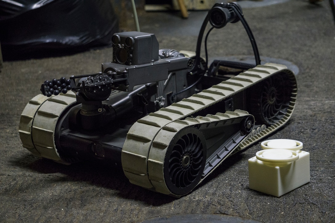 An iRobot 310 Small Unmanned Ground Vehicle belonging to Combat Logistic Battalion 31, 31st Marine Expeditionary Unit, sits staged with 3-D printed lens covers aboard the USS Wasp (LHD-1) while underway in the Pacific Ocean, April 17, 2018. Marines with CLB-31 are now capable of ‘additive manufacturing,’ also known as 3-D printing, which is the technique of replicating digital 3-D models as tangible objects.  The 31st Marine Expeditionary Unit partners with the Navy’s Amphibious Squadron 11 to form the Wasp Amphibious Ready Group, a cohesive blue-green team capable of accomplishing a variety of missions across the Indo-Pacific. (U.S. Marine Corps photo by Cpl. Stormy Mendez/Released)