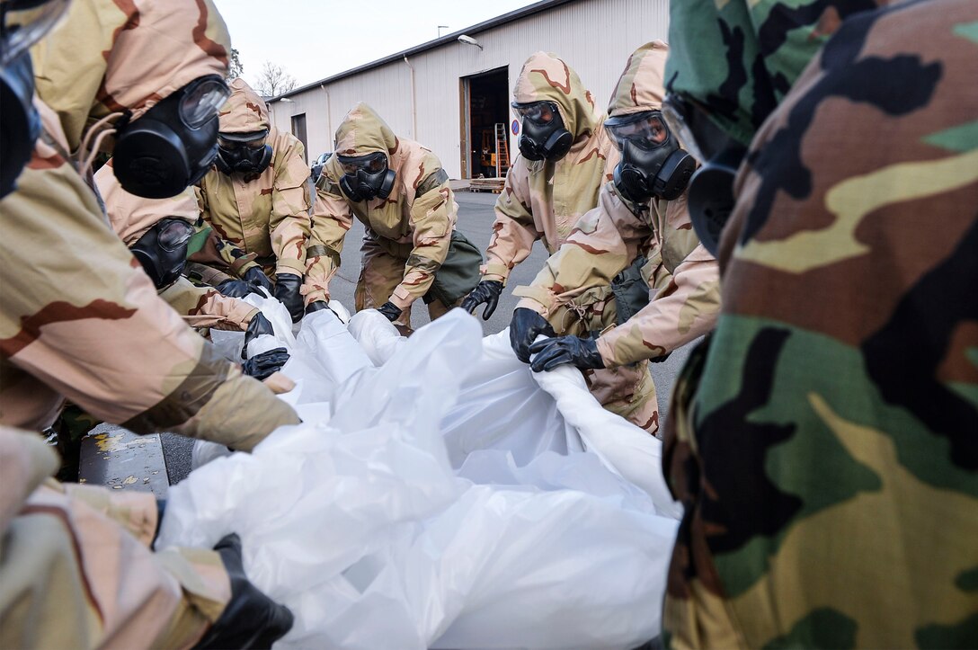 U.S. Airmen assigned to the 86th Civil Engineer Group simulate decontamination procedures during a chemical, biological, radiological, and nuclear training exercise on Ramstein Air Base, Germany, April 12, 2018. The 786th Civil Engineer Squadron’s emergency management flight helps train Airmen in matters concerning CBRN defense. (U.S. Air Force photo by Senior Airman Joshua Magbanua)