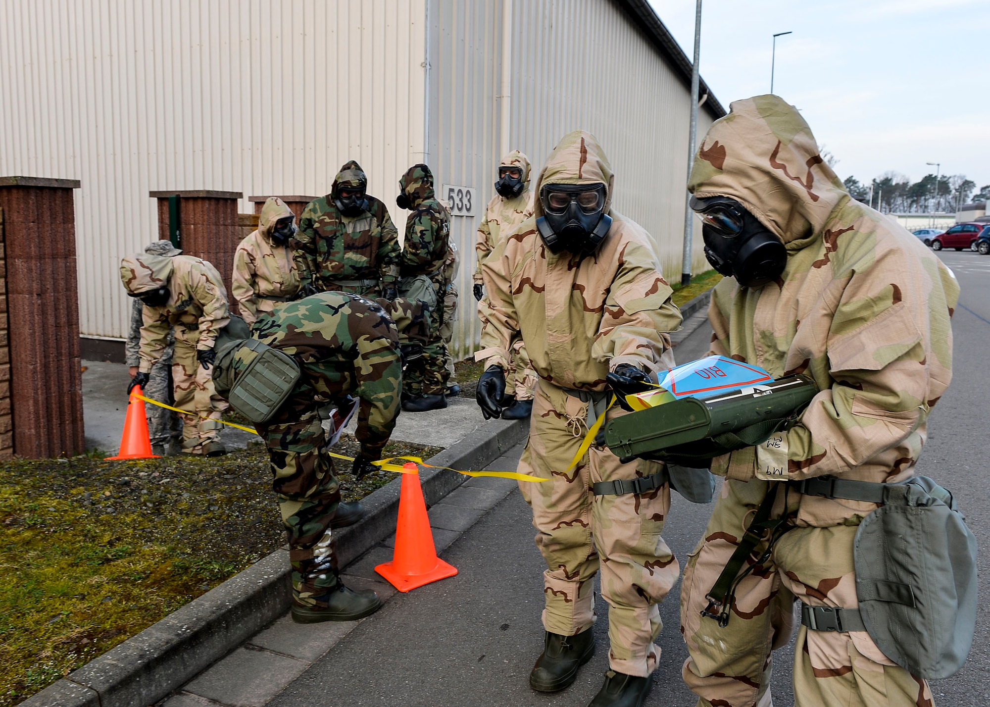 U.S. Airmen assigned to the 86th Civil Engineer Group set up a simulated cordon during a training exercise on chemical, biological, radiological, and nuclear defense on Ramstein Air Base, Germany, April 12, 2018. During CBRN training, Airmen learn how to respond against various kinds of threats. (U.S. Air Force photo by Senior Airman Joshua Magbanua)