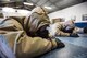 U.S. Airmen assigned to the 86th Civil Engineer Group take cover during a chemical, biological, radiological, and nuclear training exercise on Ramstein Air Base, Germany, April 12, 2018. CBRN training involves familiarization of the use of protective gear, which includes practicing putting on masks, rubber boots, gloves, and protective suits in a hazardous environment. (U.S. Air Force photo by Senior Airman Joshua Magbanua)