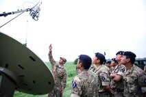 Soldiers gathered around satellite dish