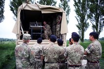 Soldiers stand near a truck