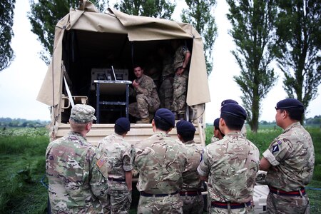 Soldiers stand near a truck