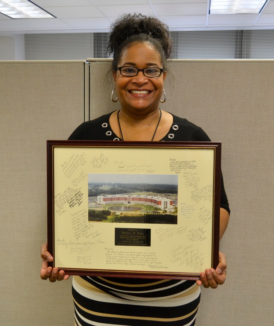 Brenda Hall, a DLA Troop Support procurement analyst, poses with her going-away gift from her time in the DLA Enterprise Rotation Program, Feb. 28, 2018 in Philadelphia.